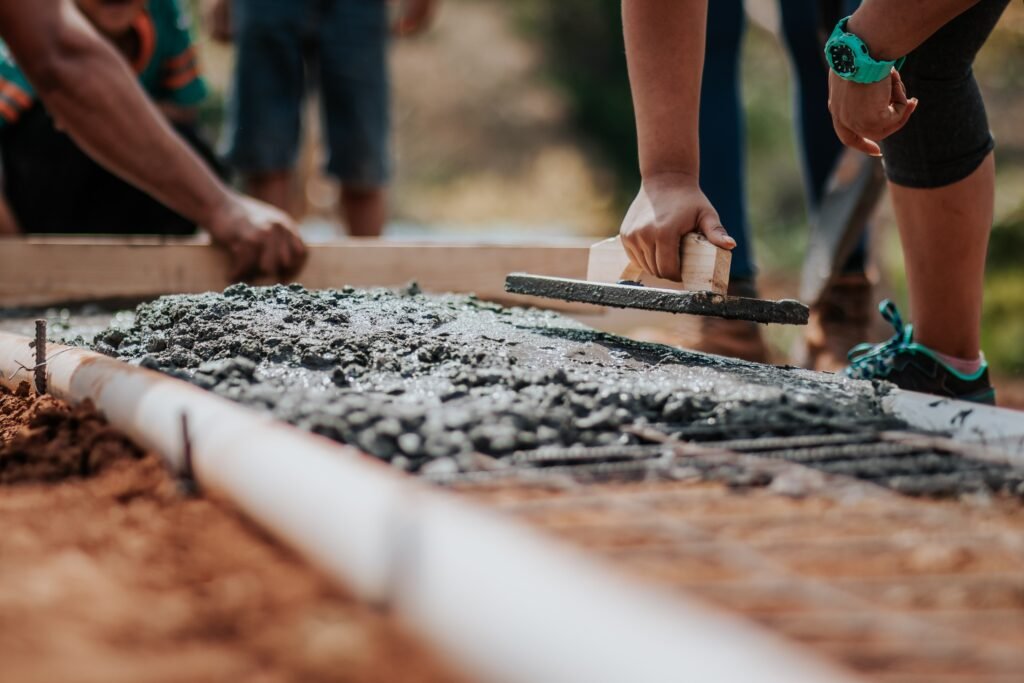 Workers levelling fresh concrete on a building site